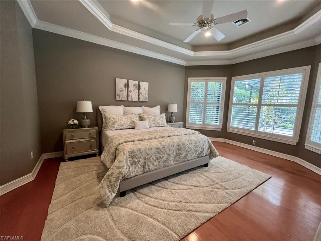 4956 Rustic Oaks Circle Naples, FL 34105 - Photo 15 of 37 a bedroom with a large bed and a large window
