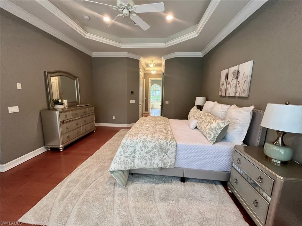 4956 Rustic Oaks Circle Naples, FL 34105 - Photo 16 of 37 a bedroom with a bed and a chandelier