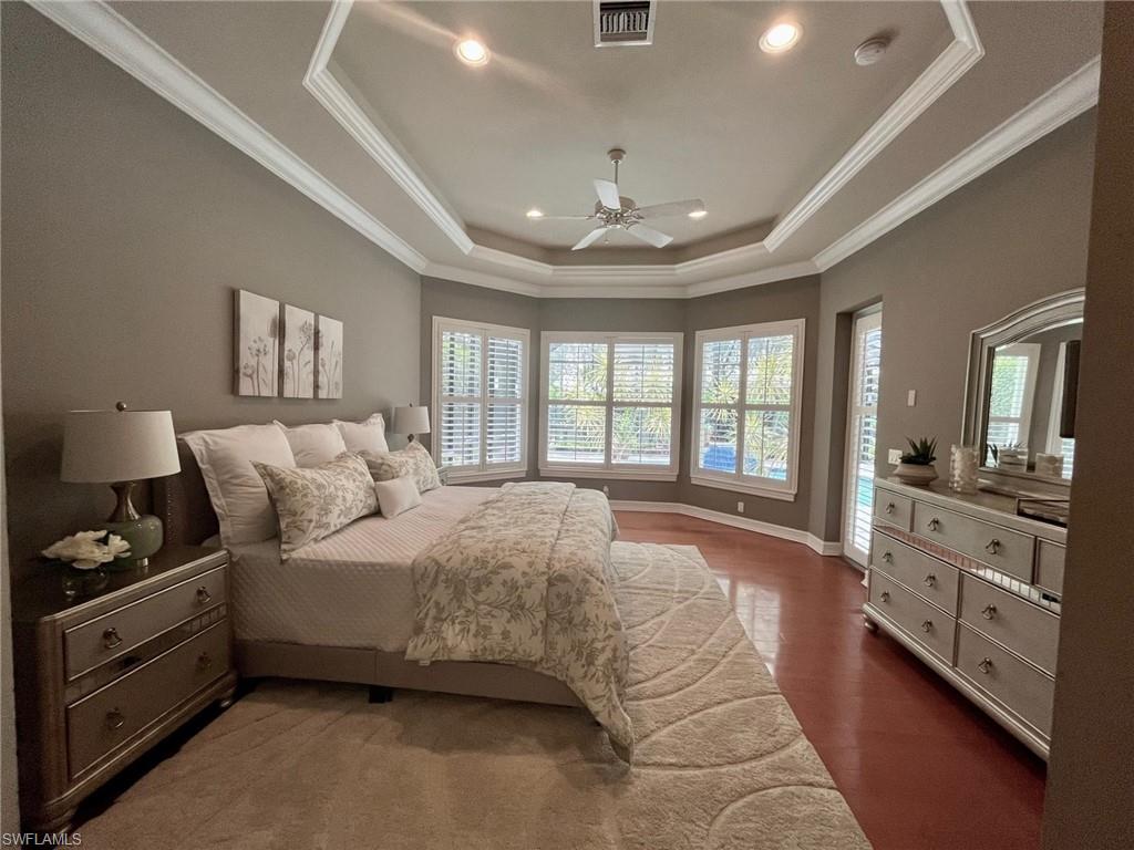 4956 Rustic Oaks Circle Naples, FL 34105 - Photo 17 of 37 a spacious bedroom with a large bed and a dresser
