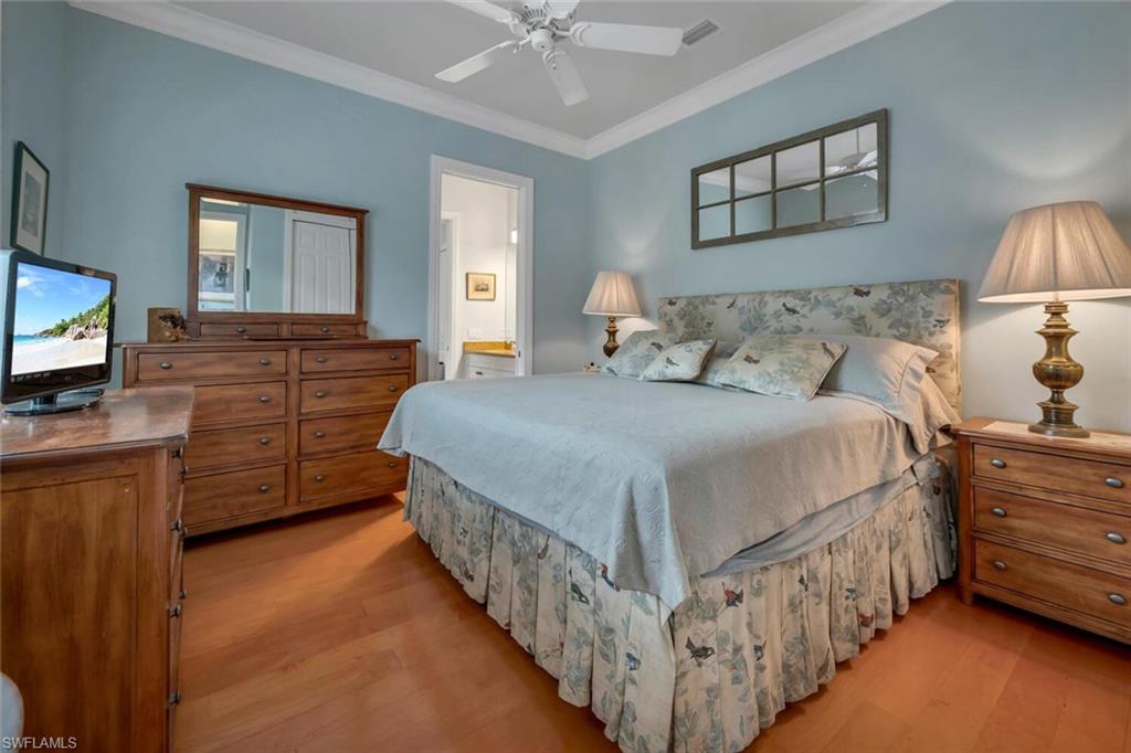 4956 Rustic Oaks Circle Naples, FL 34105 - Photo 19 of 37 a bedroom with bed and wooden floor