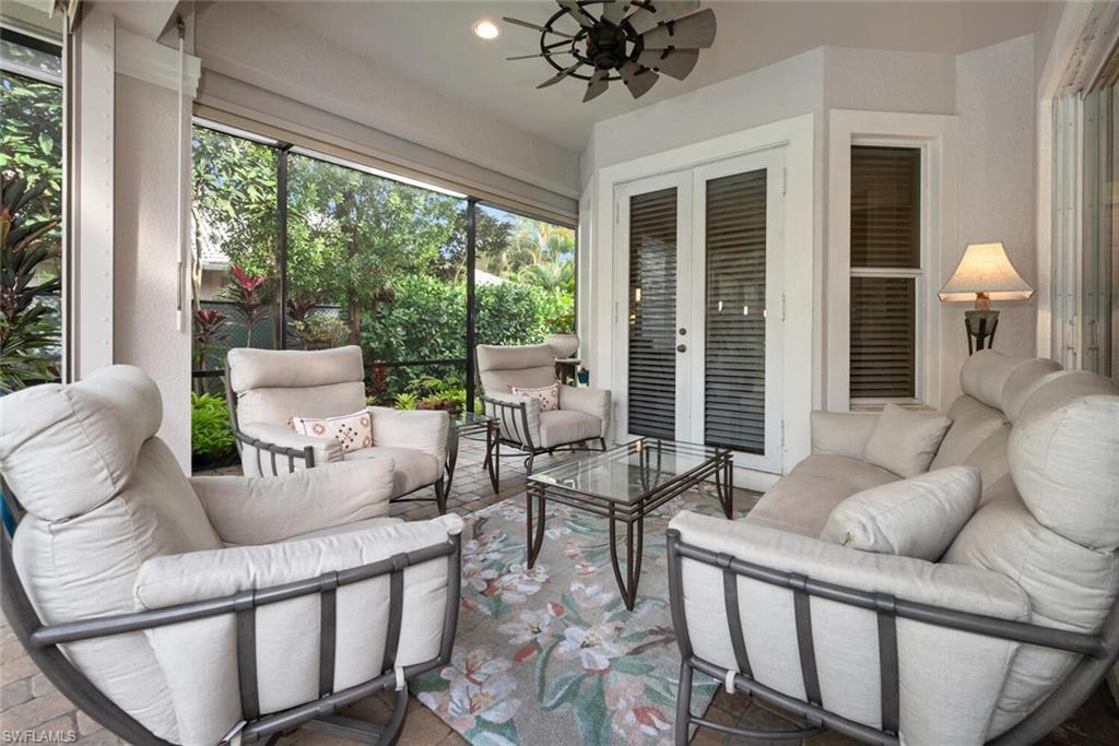 4956 Rustic Oaks Circle Naples, FL 34105 - Photo 24 of 37 a living room with furniture and a large window
