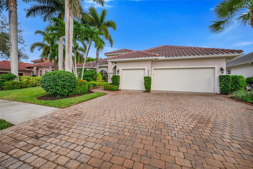 4956 Rustic Oaks Circle Naples, FL 34105 - Photo 30 of 37 a front view of a house with a yard and garage
