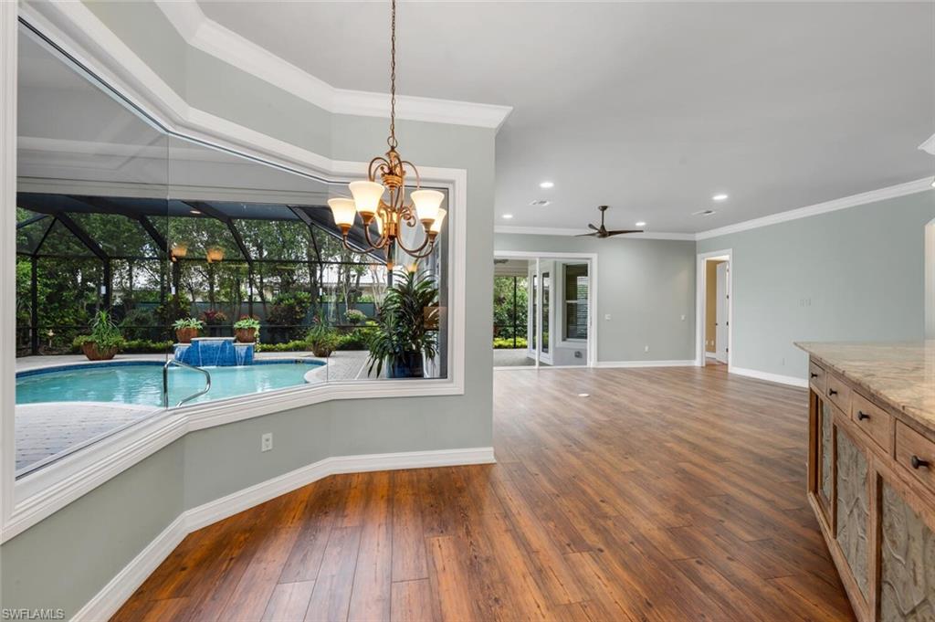 4956 Rustic Oaks Circle Naples, FL 34105 - Photo 34 of 37 a view of a livingroom with furniture wooden floor garden view