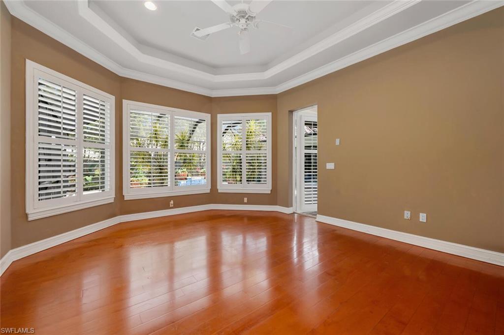 4956 Rustic Oaks Circle Naples, FL 34105 - Photo 35 of 37 a view of an empty room with a window and wooden floor