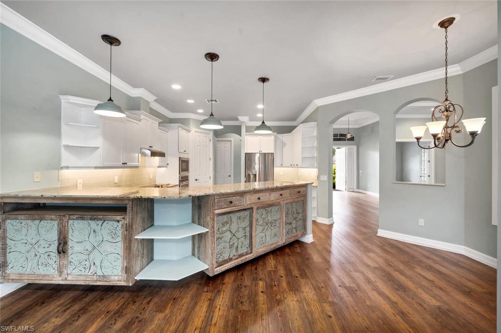 4956 Rustic Oaks Circle Naples, FL 34105 - Photo 5 of 37 a large kitchen with a lot of counter space and a sink