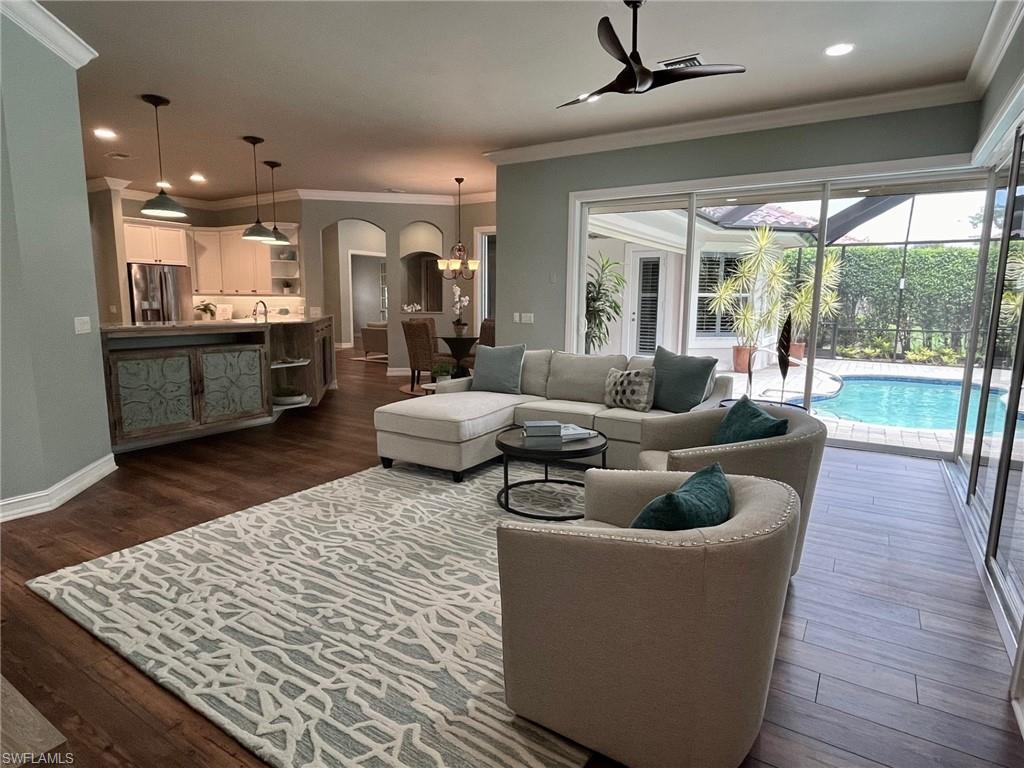4956 Rustic Oaks Circle Naples, FL 34105 - Photo 10 of 37 a living room with furniture and a large window