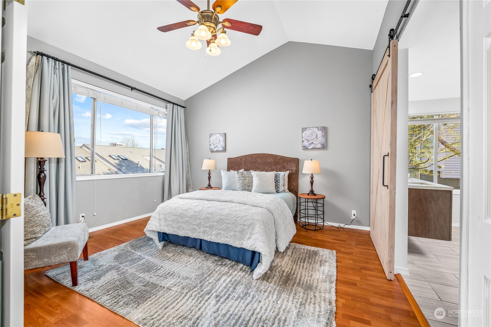 7250 Old Redmond Road, Unit M150 Redmond, WA 98052 - Photo 23 of 33 a bedroom with a bed and wooden floor