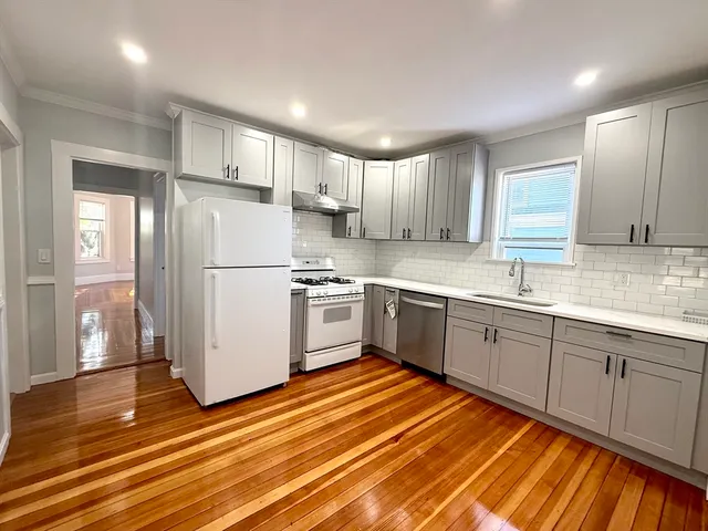 a kitchen with stainless steel appliances granite countertop a refrigerator sink and cabinets