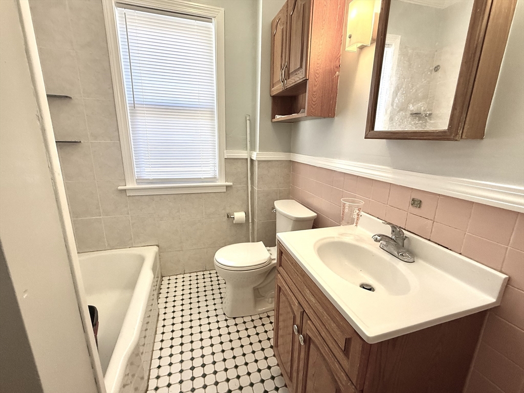 19-21 Dearborn Avenue, Unit 2 Lynn, MA 01905 - Photo 15 of 20 a bathroom with a sink a toilet and a window