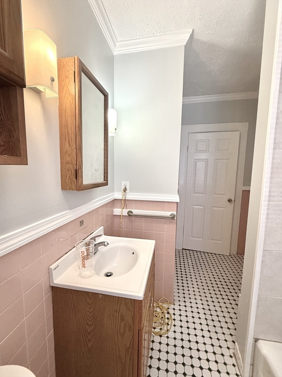 19-21 Dearborn Avenue, Unit 2 Lynn, MA 01905 - Photo 16 of 20 a bathroom with a sink a toilet and a mirror
