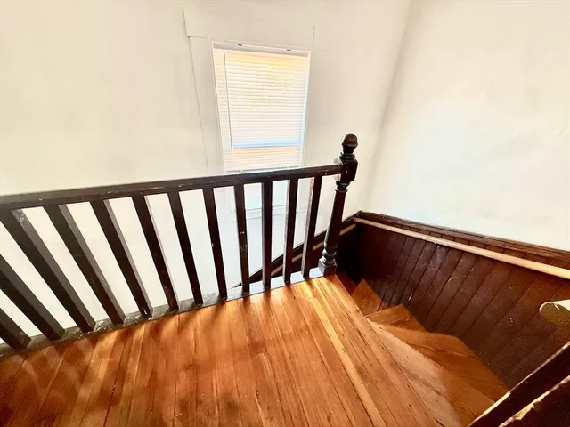 a view of a room with wooden floor