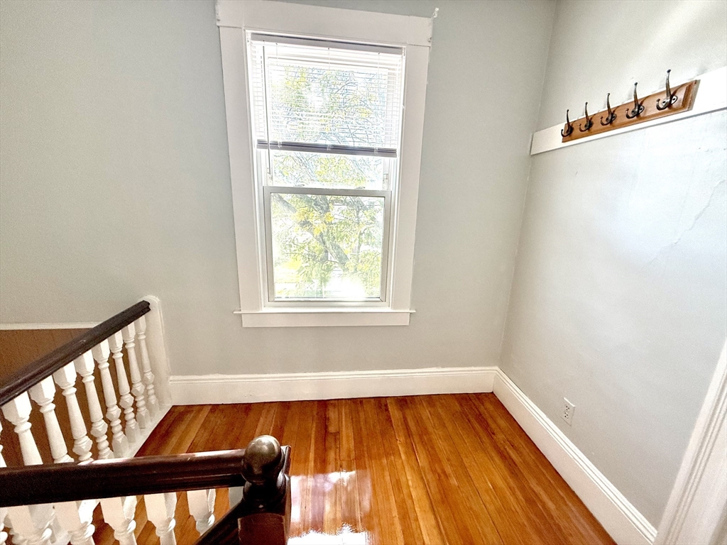 19-21 Dearborn Avenue, Unit 2 Lynn, MA 01905 - Photo 7 of 20 a view of a room with wooden floor and a window