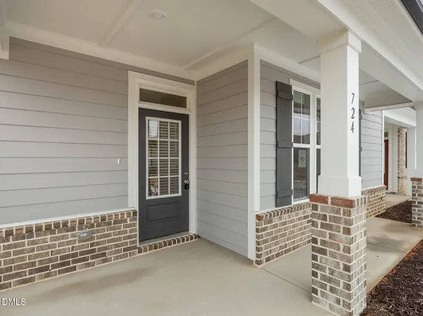 a large kitchen with stainless steel appliances granite countertop a lot of counter space and wooden floor