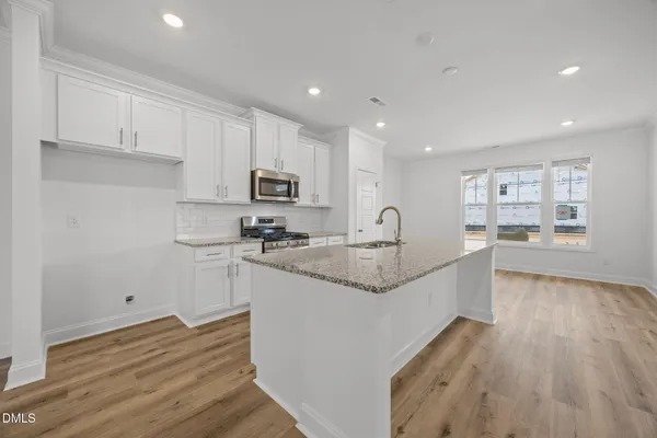 a view of kitchen and wooden floor