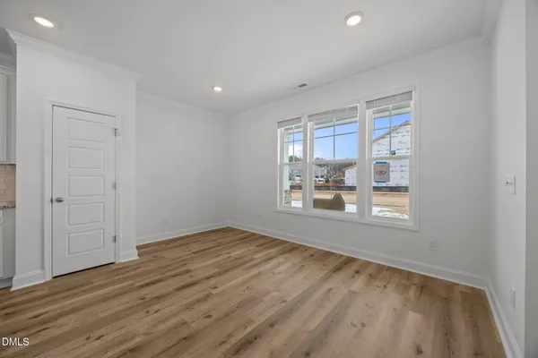 a kitchen with kitchen island granite countertop a sink window and stainless steel appliances