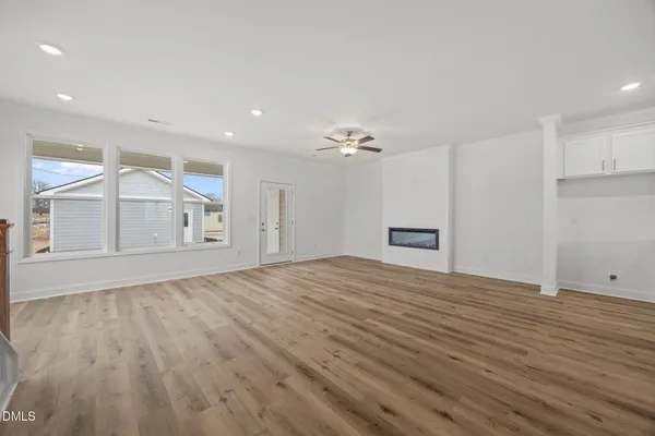 a view of an empty room with a kitchen