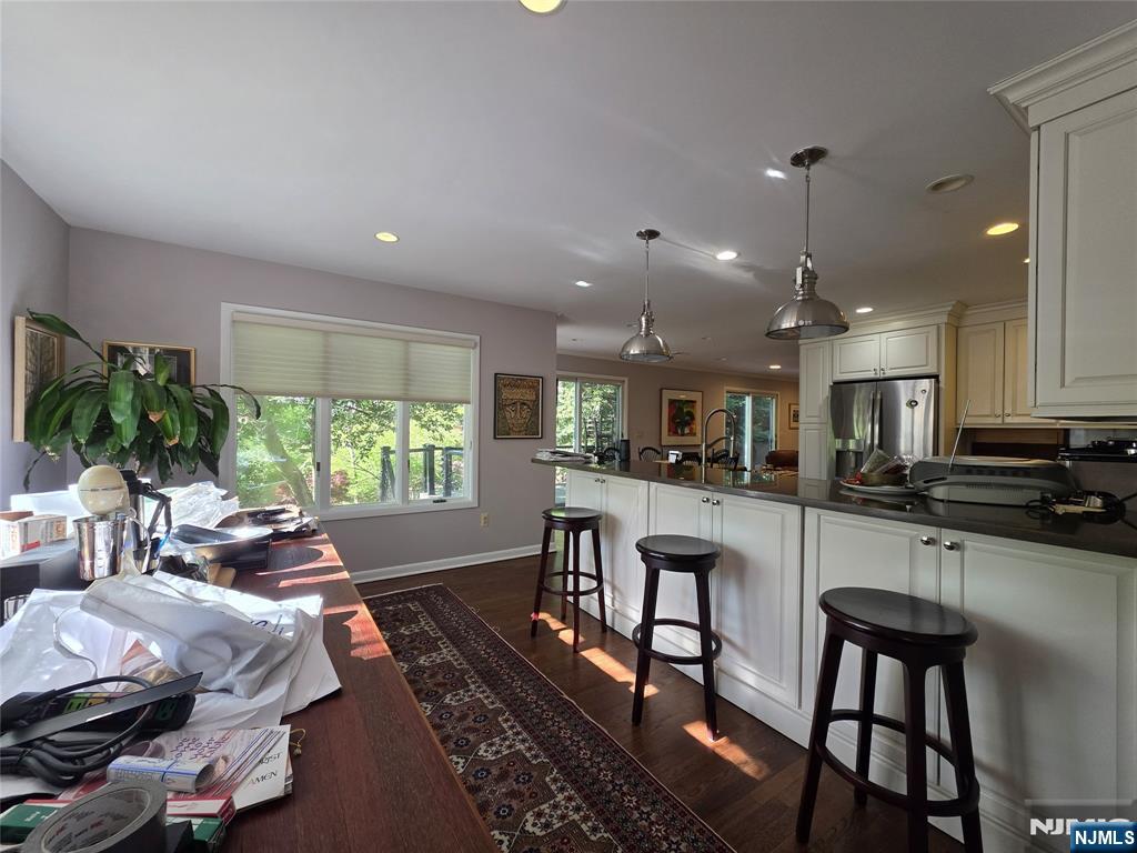 33 Cedar Lane Closter, NJ 07624 - Photo 18 of 44 a kitchen with stainless steel appliances granite countertop sink microwave and white cabinets with wooden floor