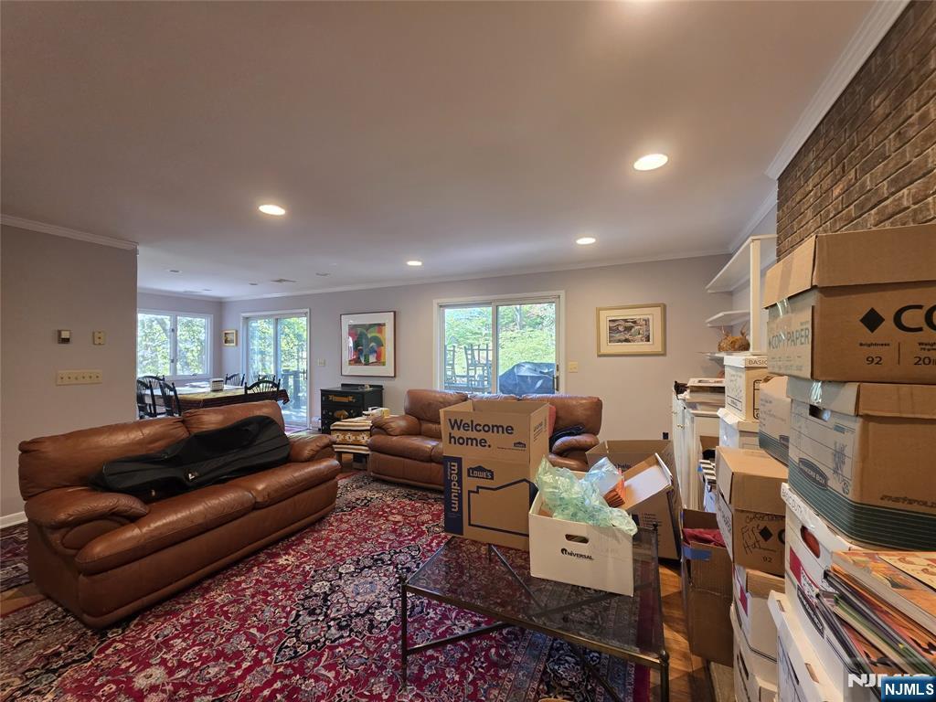 33 Cedar Lane Closter, NJ 07624 - Photo 25 of 44 a living room with furniture a flat screen tv and a window