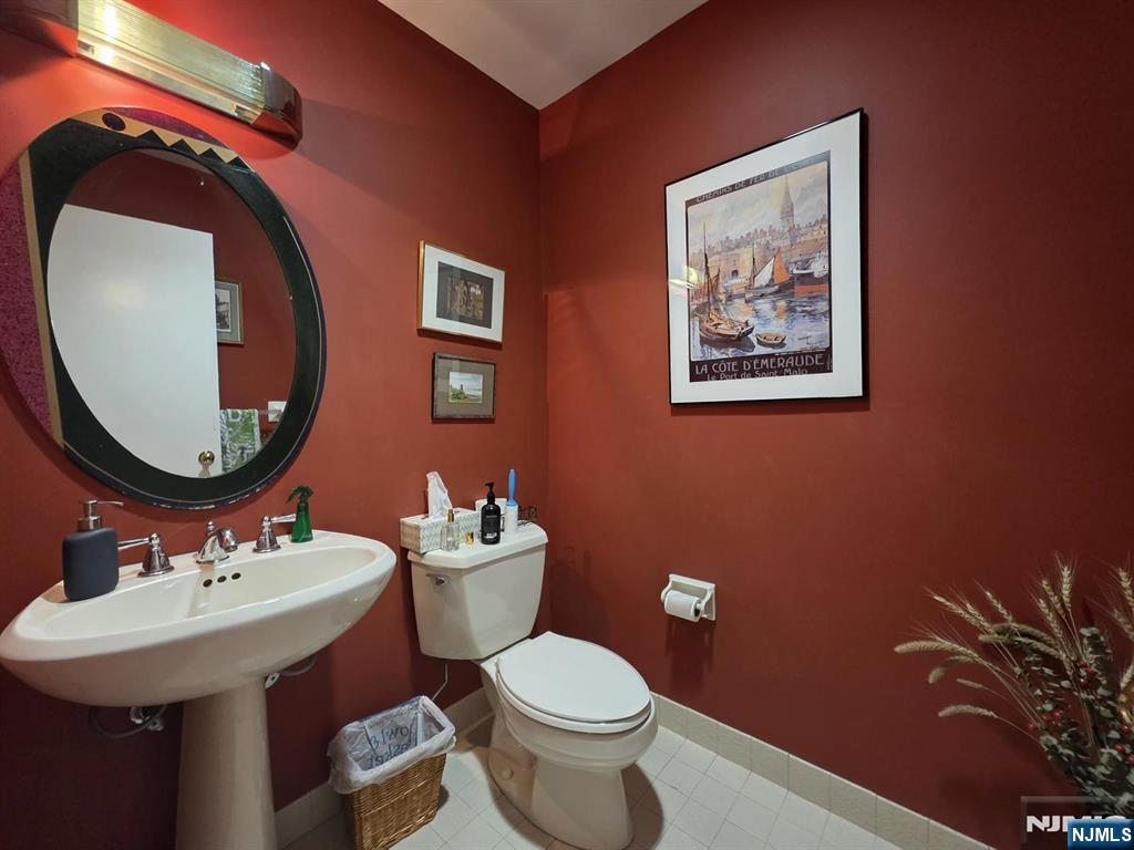 33 Cedar Lane Closter, NJ 07624 - Photo 27 of 44 a bathroom with a toilet a sink and a mirror