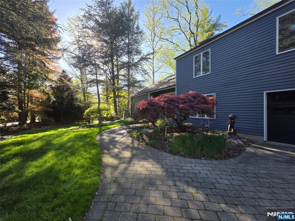 33 Cedar Lane Closter, NJ 07624 - Photo 3 of 44 a front view of a house with garden