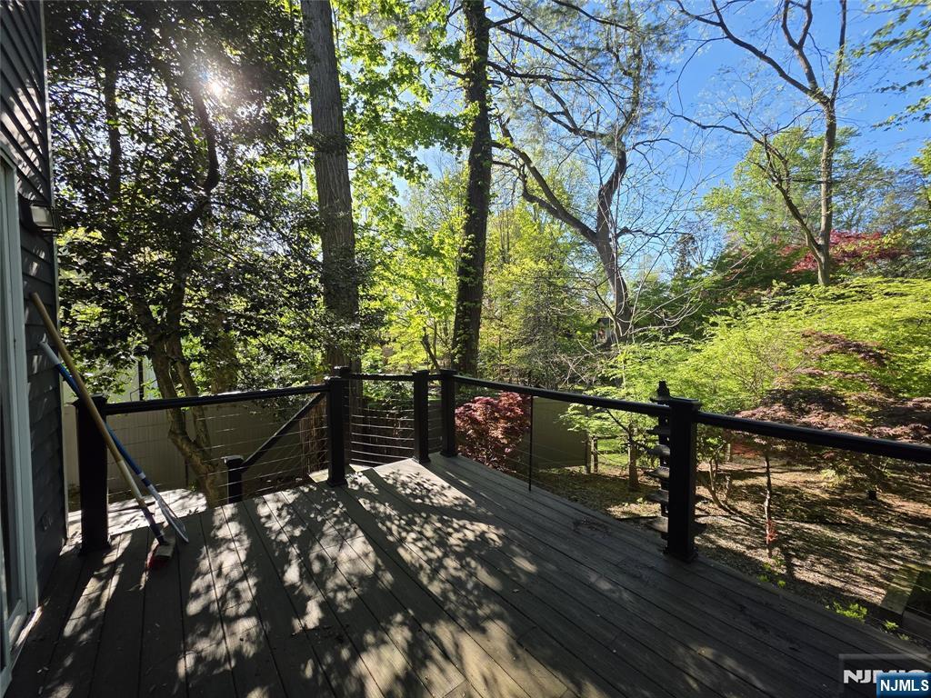 33 Cedar Lane Closter, NJ 07624 - Photo 39 of 44 a roof deck with table and chairs under an umbrella