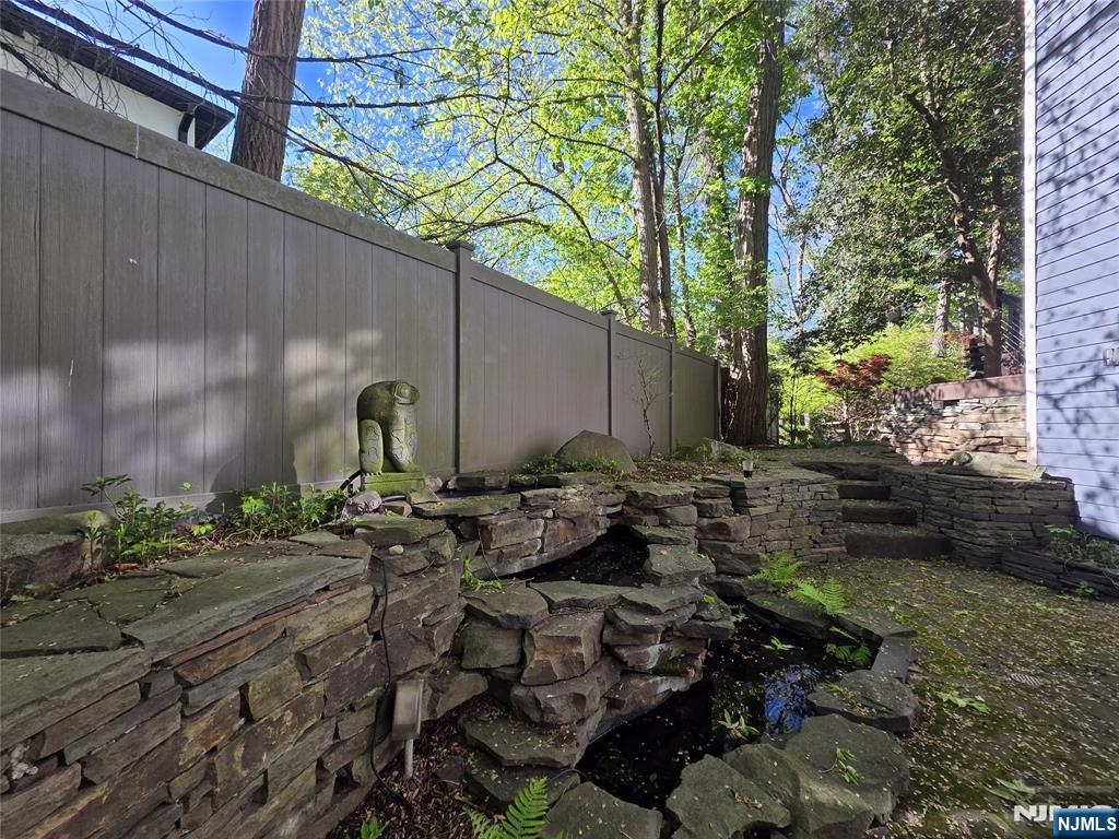 33 Cedar Lane Closter, NJ 07624 - Photo 41 of 44 a view of a backyard with chairs and potted plants