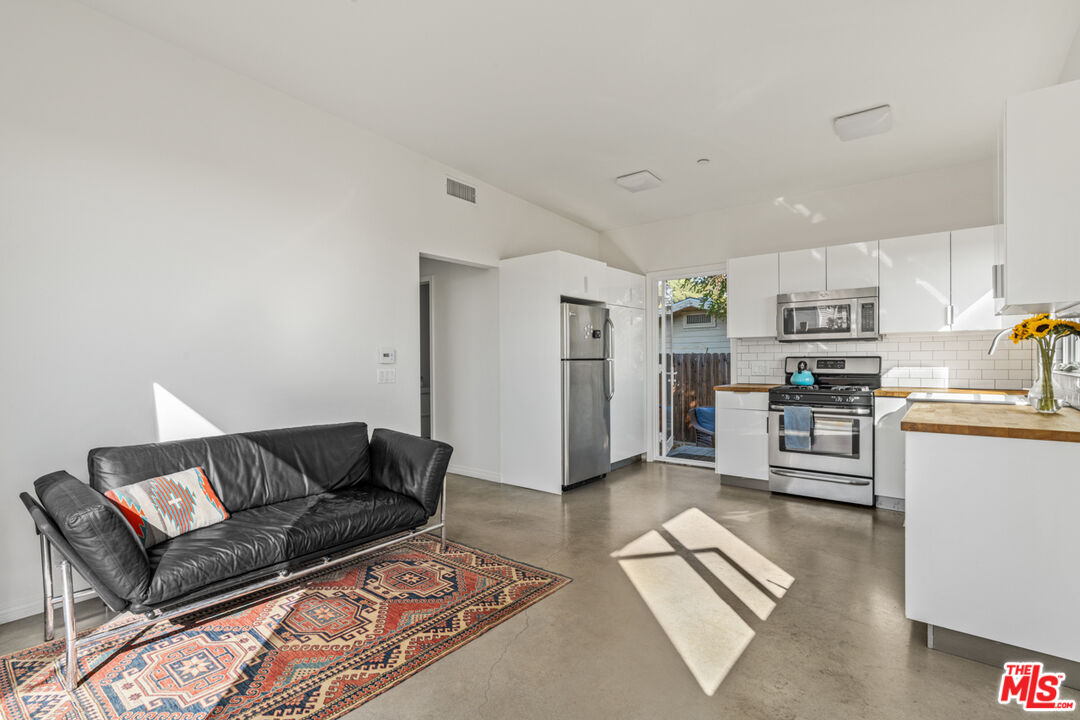 2275 Ewing Street Los Angeles, CA 90039 - Photo 3 of 19 a living room with furniture and a kitchen view