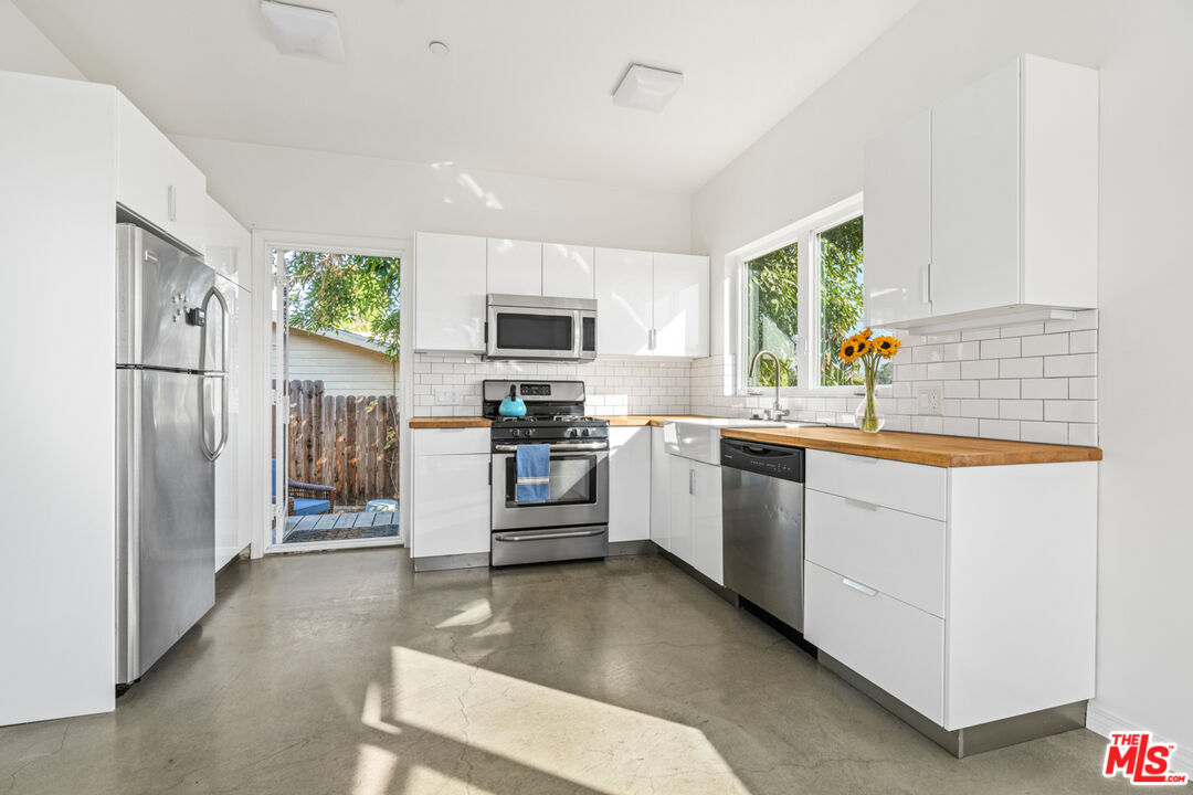 2275 Ewing Street Los Angeles, CA 90039 - Photo 7 of 19 a kitchen with stainless steel appliances a refrigerator sink and microwave