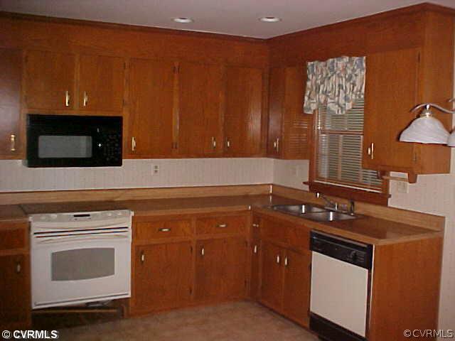 705 Fennimore Road Midlothian, VA 23114 - Photo 6 of 7 a kitchen with stainless steel appliances granite countertop a stove a microwave and oven