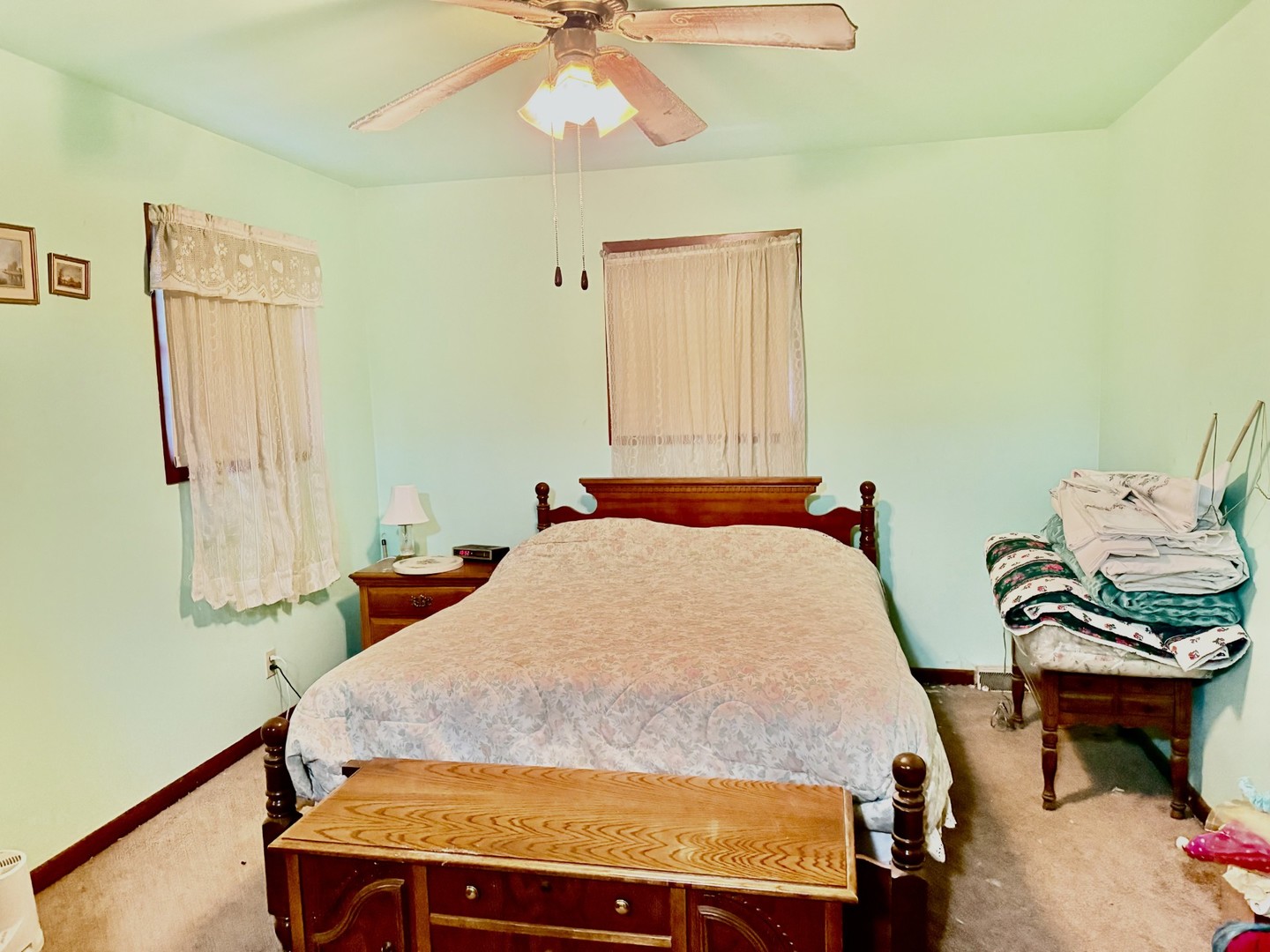 131 West Erie Street Spring Valley, IL 61362 - Photo 12 of 20 a bedroom with a bed and a chandelier