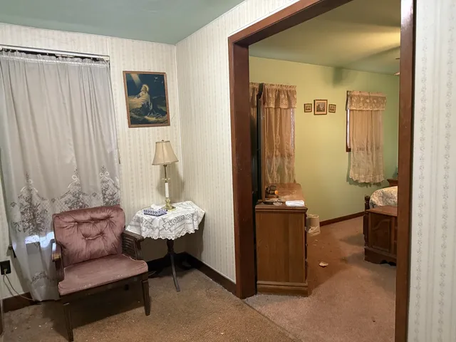 a living room with furniture and a chandelier