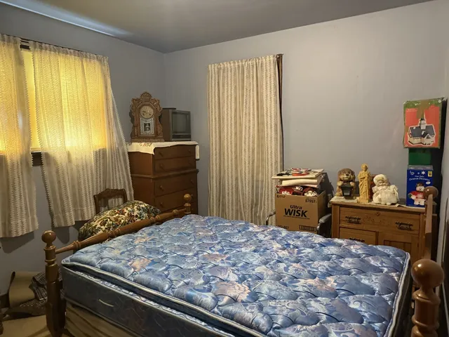 a bedroom with a bed and dresser