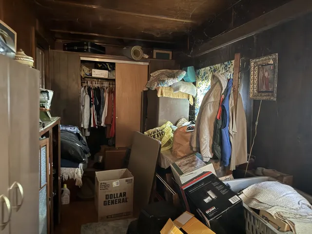 a view of walk in closet with clothes