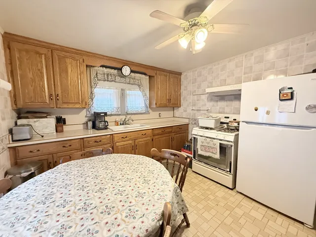 a kitchen with a stove a sink and a refrigerator