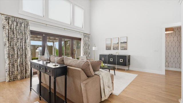 2038 East Ranch Road Eagle Mountain, UT 84005 - Photo 15 of 66 Spacious living area featuring high ceilings, wood-finish flooring, and large multi-pane windows