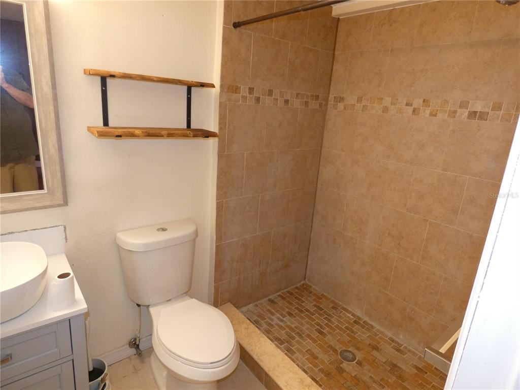 4832 Elmwood Street New Port Richey, FL 34653 - Photo 11 of 24 a white toilet sitting next to a shower curtain