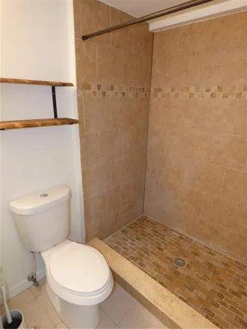a bathroom with a toilet and a shower