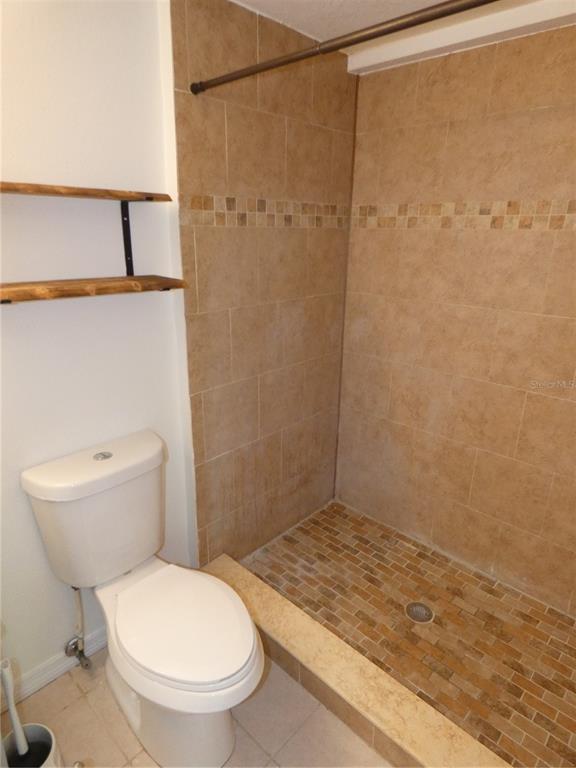 4832 Elmwood Street New Port Richey, FL 34653 - Photo 12 of 24 a bathroom with a toilet and a shower