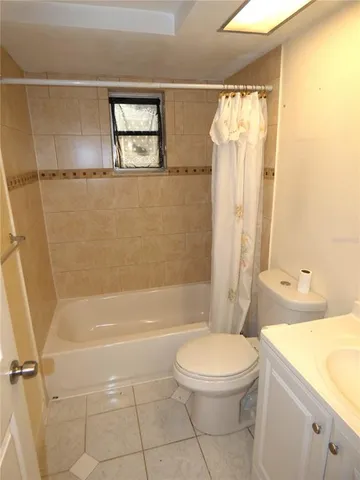a bathroom with a toilet sink and shower
