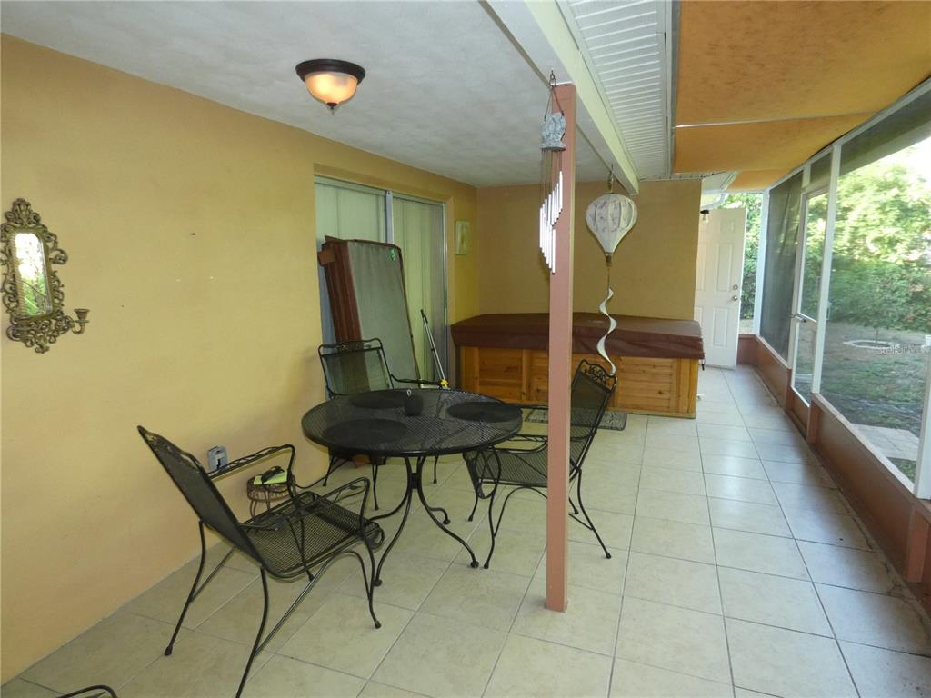 4832 Elmwood Street New Port Richey, FL 34653 - Photo 19 of 24 a view of a chairs and table in a patio