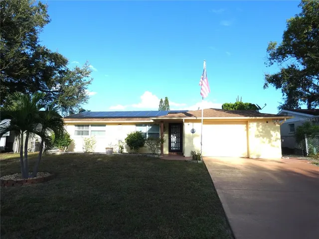 a view of a house with a yard and a garage