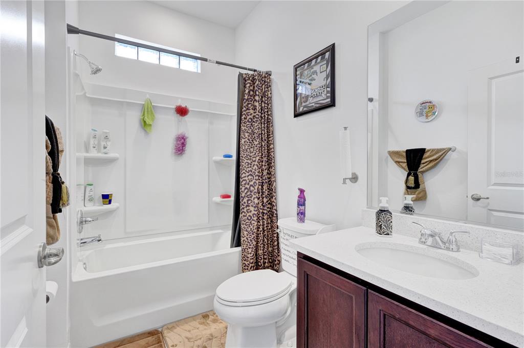 7185 Southwest 63rd Street Ocala, FL 34474 - Photo 22 of 31 a bathroom with a sink a toilet and a bathtub