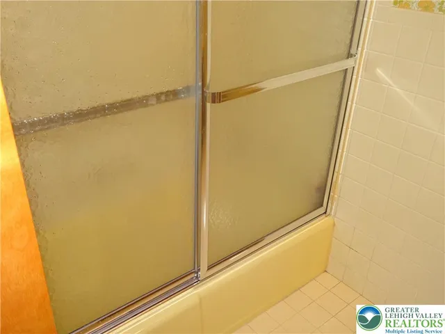 a bathroom with a glass shower door