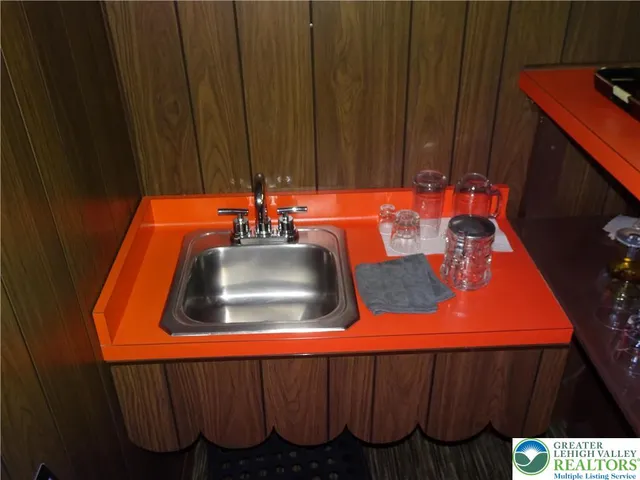 a kitchen with a sink and wooden cabinets