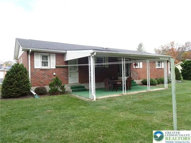 a view of an house with backyard space and garden