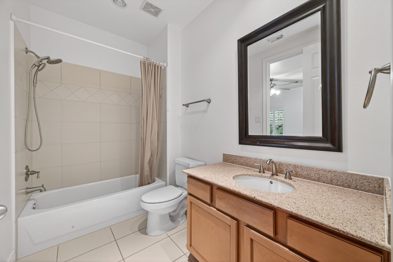 10932 Lasso Lane Houston, TX 77079 - Photo 26 of 38 a bathroom with a granite countertop sink a toilet and shower