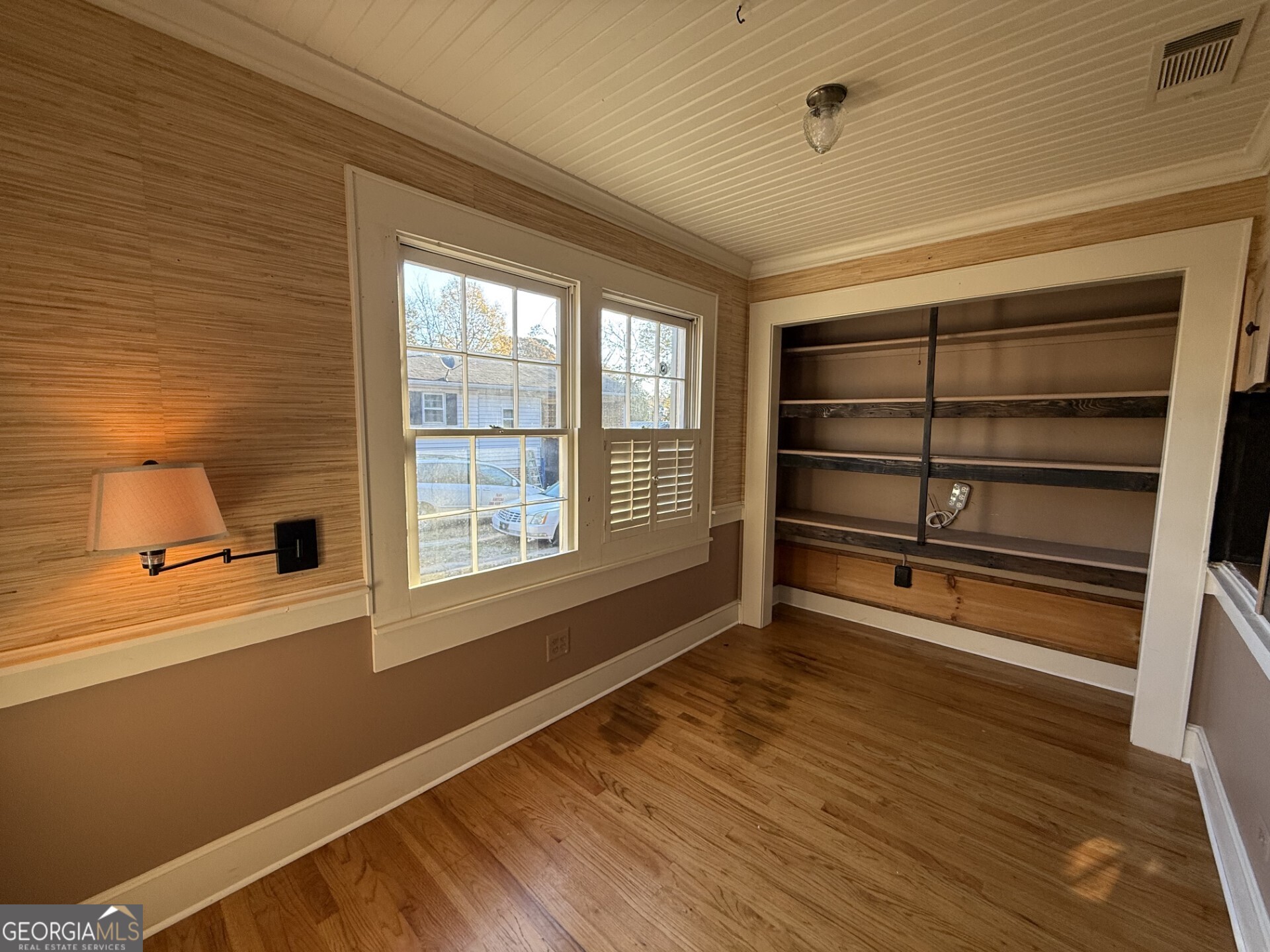 952 Wayside Street Northwest Cornelia, GA 30531 - Photo 14 of 50 a view of an empty room with a window and wooden floor
