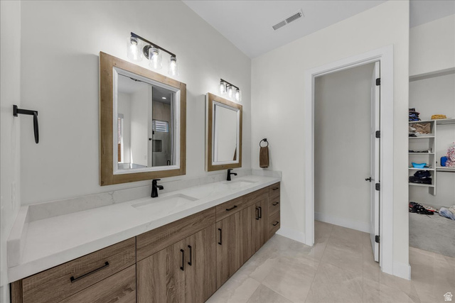 404 North Marsala Way St. George, UT 84770 - Photo 15 of 26 Full bath featuring double vanity, a spacious closet, and light tile patterned floors