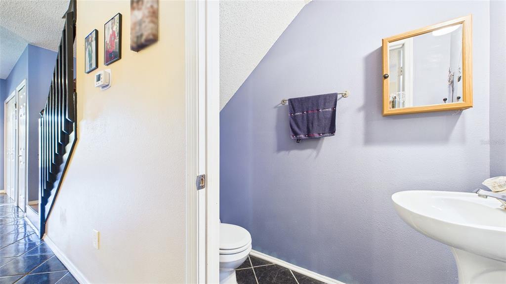 1250 Redondo Way Wesley Chapel, FL 33543 - Photo 11 of 27 a bathroom with a toilet sink and mirror