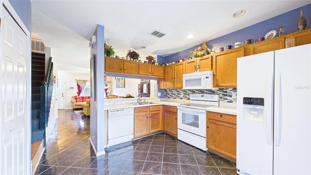 1250 Redondo Way Wesley Chapel, FL 33543 - Photo 14 of 27 a kitchen with a stove a refrigerator and a sink